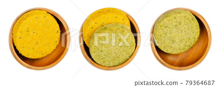 Vegetable patties in wooden bowls. Ready to fry vegan patties, made of butternut pumpkin or broccoli, on a soy and wheat protein base. Convenience food. Close-up isolated over white, macro food photo. 79364687