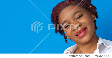 Portrait of nice attractive african american woman against blue background 79364854