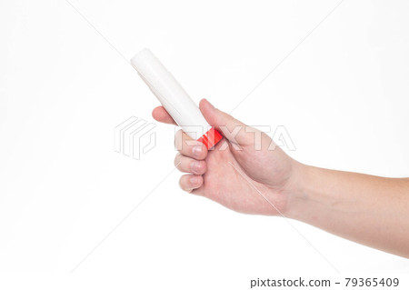 Man holds a glue stick in his hand on a white background, isolate. Close-up 79365409