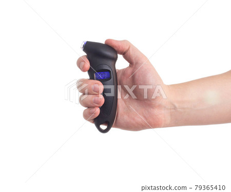 Man holds in his hand a modern electronic car tire pressure gauge, white background, isolate. Diagnostic 79365410