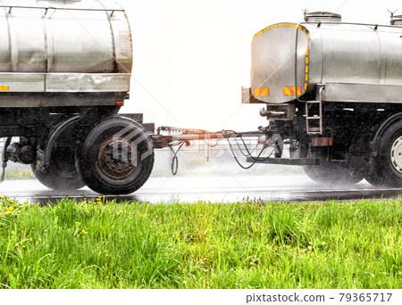 Drawbar coupling of a semi-trailer in a milk tanker traveling in wet rainy weather, close-up Drawbar coupling of a semi-trailer in a milk tanker traveling in wet rainy weather, close-up 79365717