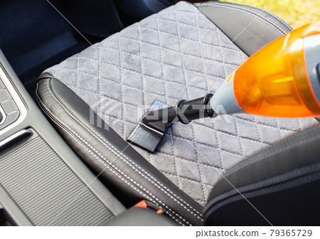 Cleaning a modern car interior with a vacuum cleaner from dirt and dust, background. Equipment 79365729