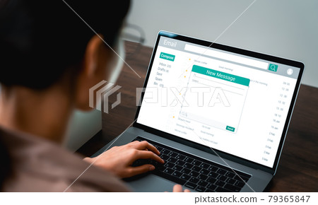Woman using computer on table with new email message on laptop 79365847