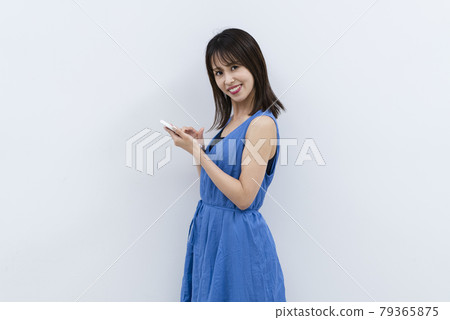 Woman using a smartphone Woman using a smartphone 79365875