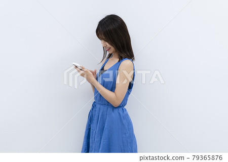 Woman using a smartphone Woman using a smartphone 79365876