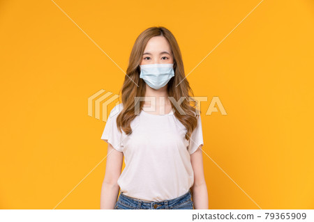 Asian woman wear masks to protect disease on yellow background. Asian woman wear masks to protect disease on yellow background. 79365909
