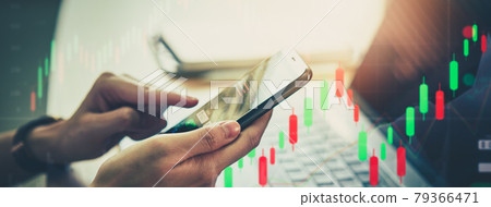 Stock exchange market concept, hand using smartphone with graphs analysis candle line 79366471