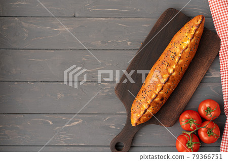 Turkish stuffed flatbread pide on gray wooden table Turkish stuffed flatbread pide on gray wooden table 79366751