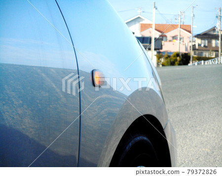 Turn signal attached to the fender of the car (lit) 79372826