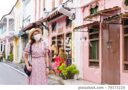 Travelers on street Phuket old town with Building Sino Portuguese architecture at Phuket Old Town area Phuket, Thailand. Travel concept Travelers on street Phuket old town with Building Sino Portuguese architecture at Phuket Old Town area Phuket, Thailand. Travel concept 79373220
