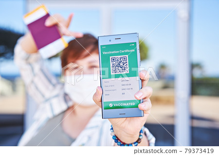 Happy woman holding smartphone displaying on app mobile valid digital green vaccination certificate for Covid-19. Immunity vaccine passport, vaccination certificate, health passport for travel Happy woman holding smartphone displaying on app mobile valid digital green vaccination certificate for Covid-19. Immunity vaccine passport, vaccination certificate, health passport for travel 79373419