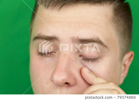Tears in eyes of crying adult man. Green background. Chromakey Tears in eyes of crying adult man. Green background. Chromakey 79374860