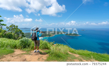 Travel man photographer standing on rock to see landscape view at Phahindum viewpoint popular landmark in Phuket Thailand Viewpoint to see promthep cape Naiharn beach and yanui beach Amazing view Travel man photographer standing on rock to see landscape view at Phahindum viewpoint popular landmark in Phuket Thailand Viewpoint to see promthep cape Naiharn beach and yanui beach Amazing view 79375244