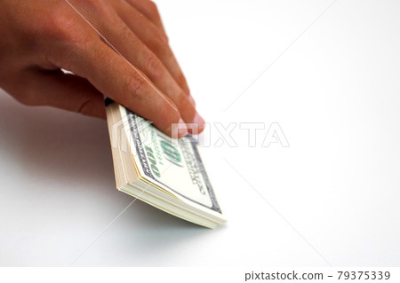 Tanned afro hand holding a bundle of dollars isolated on white background 79375339