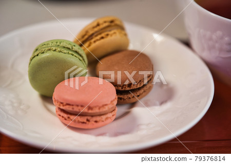 Colorful macaroons on white tableware 79376814