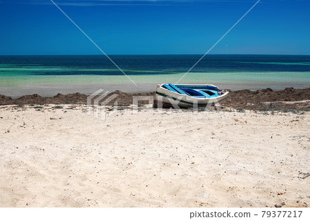 Wonderful views of the Mediterranean coast with birch water, white sand beach and a fishing boat Wonderful views of the Mediterranean coast with birch water, white sand beach and a fishing boat 79377217