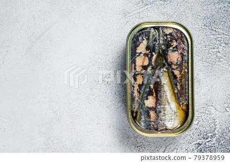 Open can with sardine in olive oil. White background. Top view. Copy space 79378959