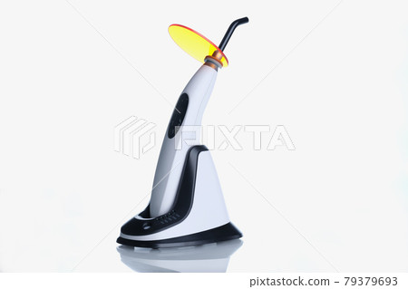 Closeup of dental equipment curing light on white background Closeup of dental equipment curing light on white background 79379693
