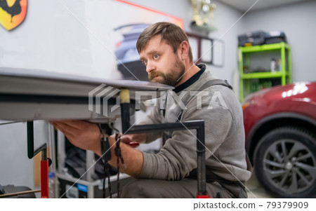 Bearded man's car repair service worker, hands photo in work process Bearded man's car repair service worker, hands photo in work process 79379909