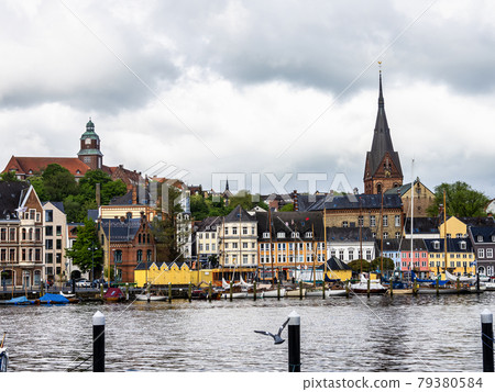 Sail boats in the port of Flensburg, St. Jorgen's Church in the background. Schleswig-Holstein in Germany Sail boats in the port of Flensburg, St. Jorgen's Church in the background. Schleswig-Holstein in Germany 79380584