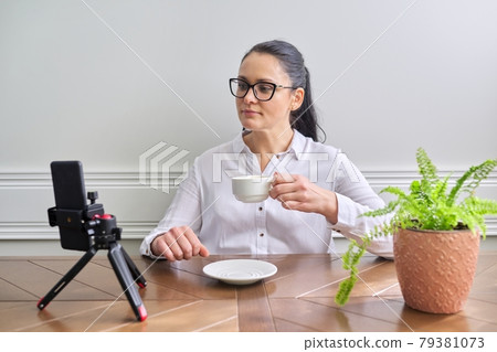 Young woman blogger vlogger recording broadcast at home 79381073