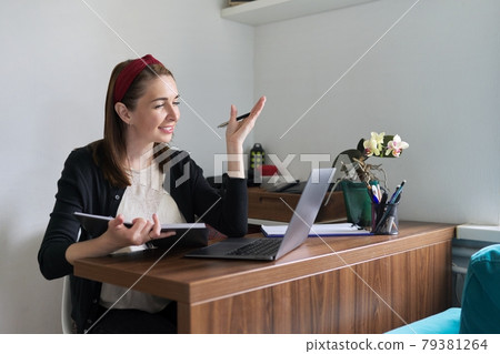 Businesswoman, female teacher working online at home with laptop using video call Businesswoman, female teacher working online at home with laptop using video call 79381264