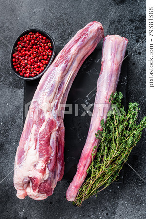 Fresh Raw whole Beef veal Oxtail Meat on marble board with herbs. Black background. Top view Fresh Raw whole Beef veal Oxtail Meat on marble board with herbs. Black background. Top view 79381388