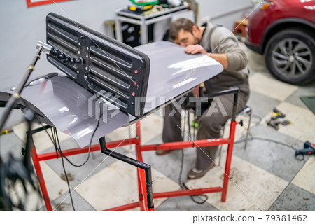 Bearded man's car repair service worker, hands photo in work process 79381462