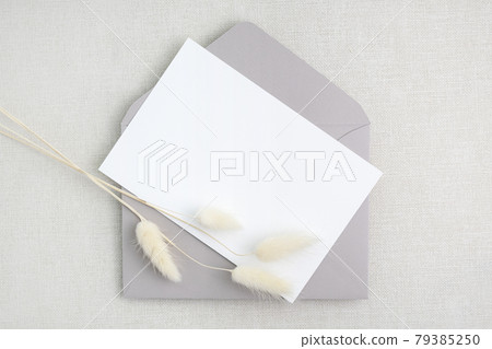 Mockup of card and envelope with plants on linen background 79385250