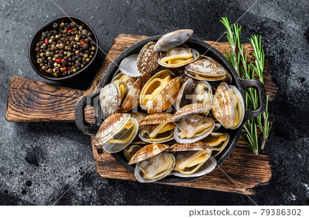 Cooked Clams vongole in a pan. Black background. Top view Cooked Clams vongole in a pan. Black background. Top view 79386302