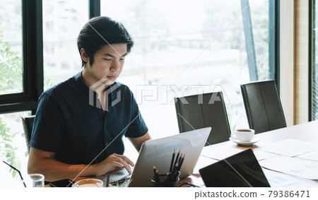 Young asian man working at home with laptop computer. Business Financial Concept Young asian man working at home with laptop computer. Business Financial Concept 79386471