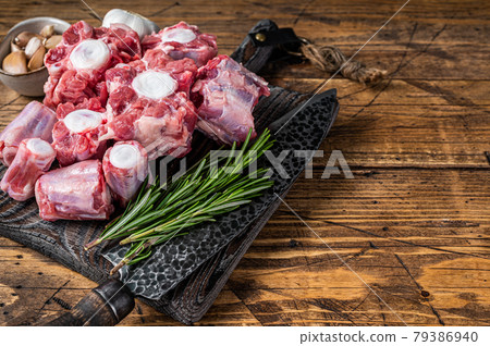 Raw beef Oxtail cut Meat on wooden cutting board with knife. wooden background. Top view. Copy space 79386940