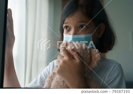 Asian little girl wearing medical protective face mask Asian little girl wearing medical protective face mask 79387193