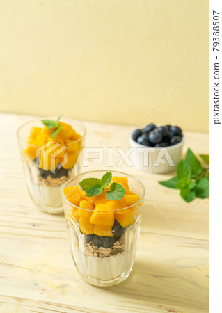 homemade mango and blueberry with yogurt and granola 79388507