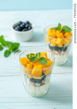 homemade mango and blueberry with yogurt and granola 79388508