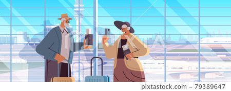 elderly couple of tourists grandparents with luggage passports and tickets ready to boarding at airport vacation traveling 79389647