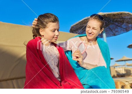 Happy mother and daughter child having fun on the beach Happy mother and daughter child having fun on the beach 79390549