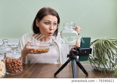 Nutritionist talks about benefits of soaking nuts in water, recording video blog vlog Nutritionist talks about benefits of soaking nuts in water, recording video blog vlog 79390821