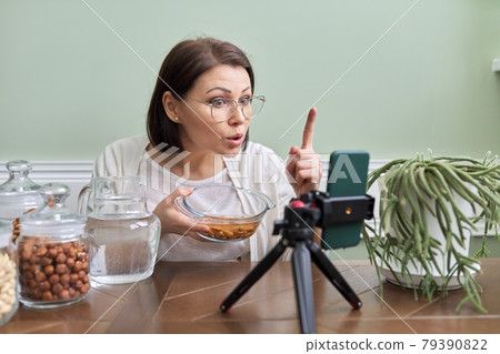 Nutritionist talks about benefits of soaking nuts in water, recording video blog vlog Nutritionist talks about benefits of soaking nuts in water, recording video blog vlog 79390822