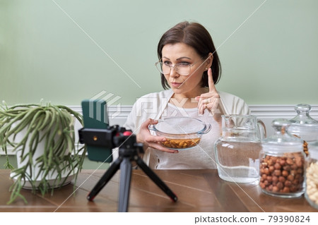 Nutritionist talks about benefits of soaking nuts in water, recording video blog vlog 79390824
