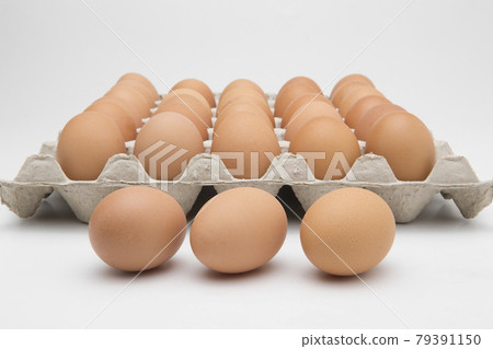 Eggs in paper tray isolated on white Eggs in paper tray isolated on white 79391150