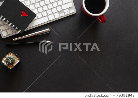 Black desk office with laptop, smartphone and other work supplies with cup of coffee. Top view with copy space for input the text. Designer workspace on desk table essential elements on flat lay. Black desk office with laptop, smartphone and other work supplies with cup of coffee. Top view with copy space for input the text. Designer workspace on desk table essential elements on flat lay. 79391942