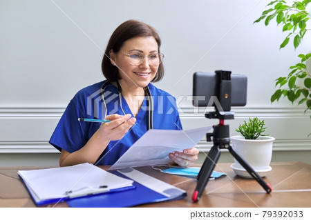 Online doctor consultation, female talking with patient using video call 79392033