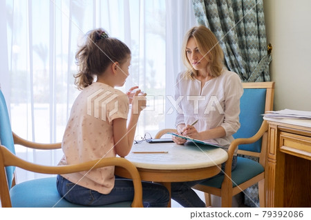 Child girl at session with social worker, school psychologist in office 79392086
