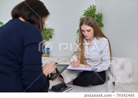 Young woman at meeting with psychologist in office 79392495
