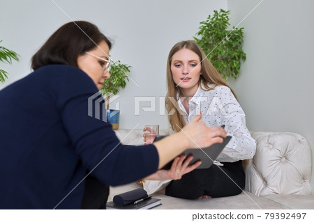 Young woman at meeting with psychologist in office 79392497