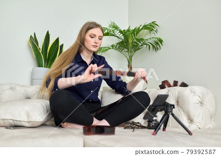 Young woman with vintage camera, photographic films, blogger recording stream 79392587