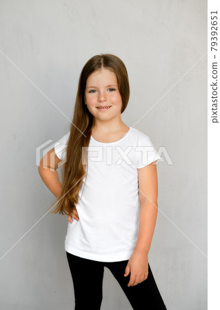 Cute young child with long hair in white t-shirt and black sweatpants Cute young child with long hair in white t-shirt and black sweatpants 79392651