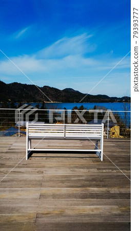 White bench facing the blue sky and the sea 79393777