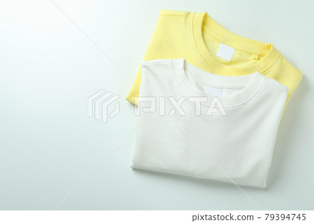 White and yellow sweatshirts on white background 79394745